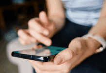 Why Crypto Apps Are Going Social Person using a crypto trading app with social feed features on smartphone.